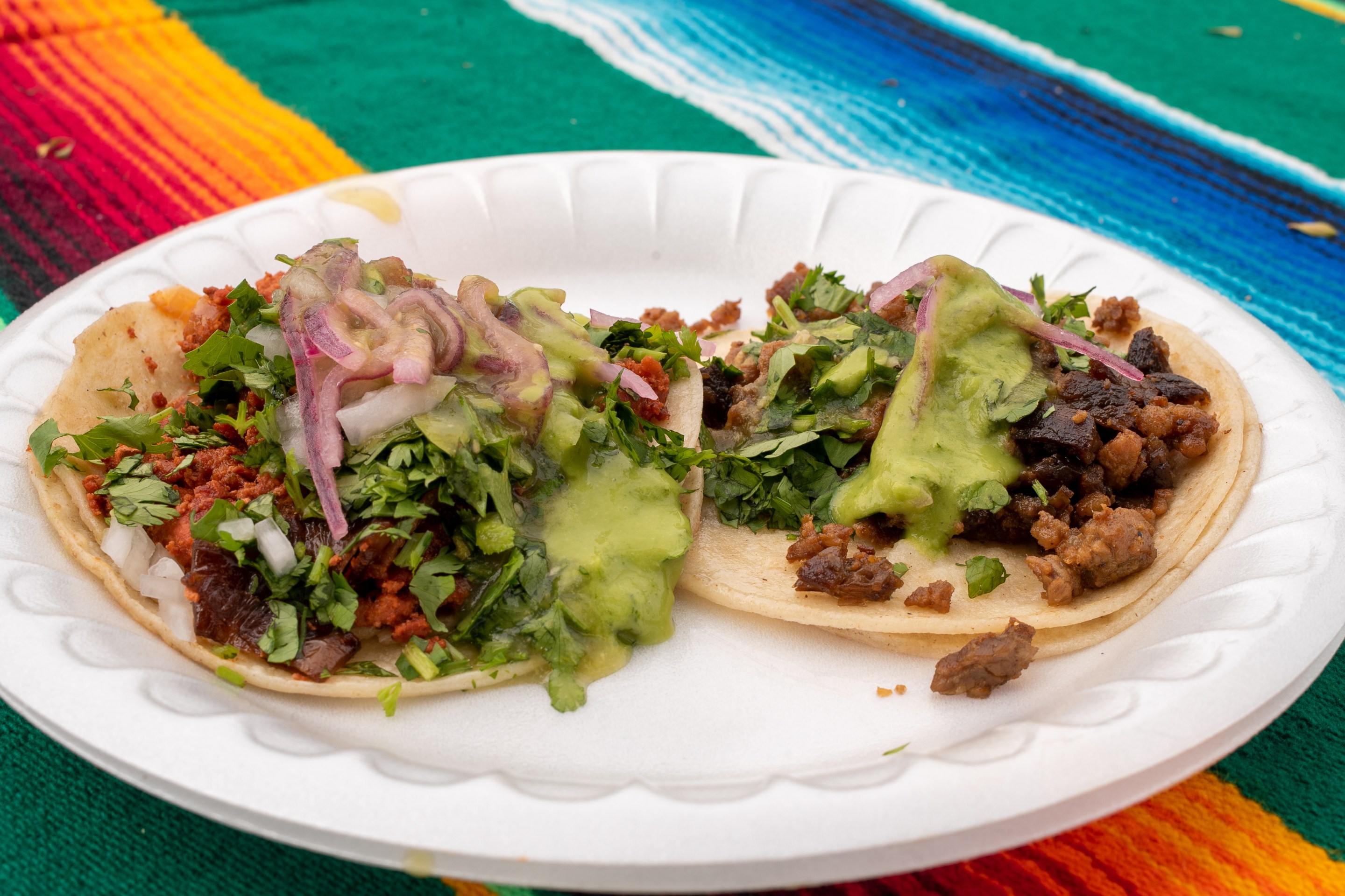 A taco de asada and a taco de chicharrón at Tacos de Canasta