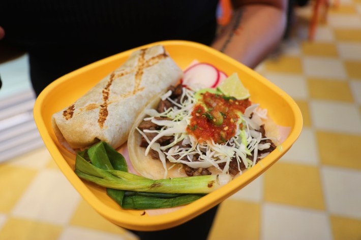 Sonoratown's costilla taco with grilled steak topped with avocado salsa, spicy red salsa, and cabbage, all placed on a flour tortilla. And their chicken Chivichanga.